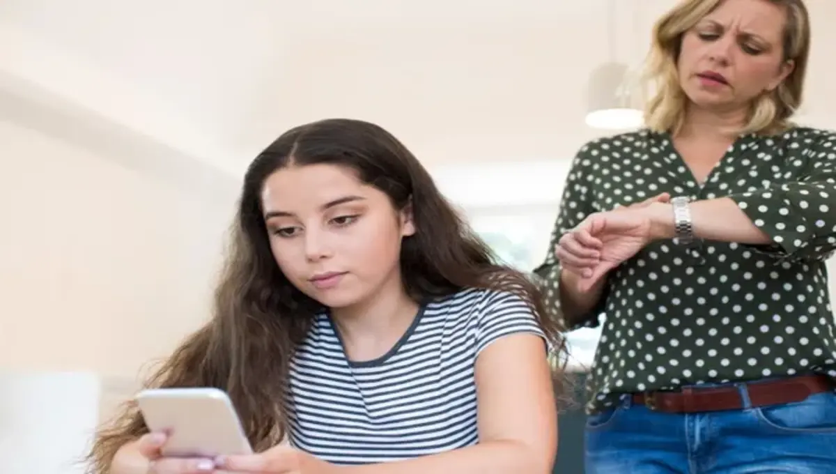 a coupel of girls sit on floor.